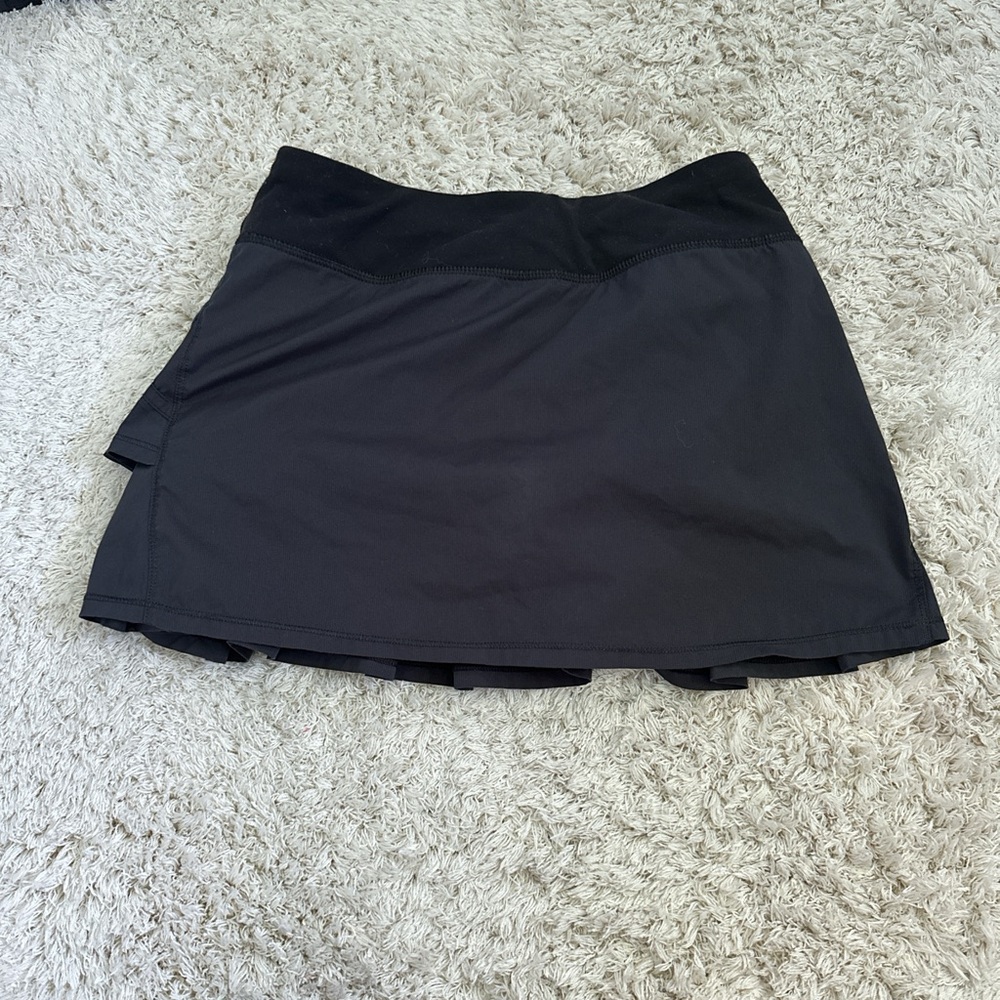 Black ruffled mini tennis skirt 
Lululemon discontinued kids brand Ivivva